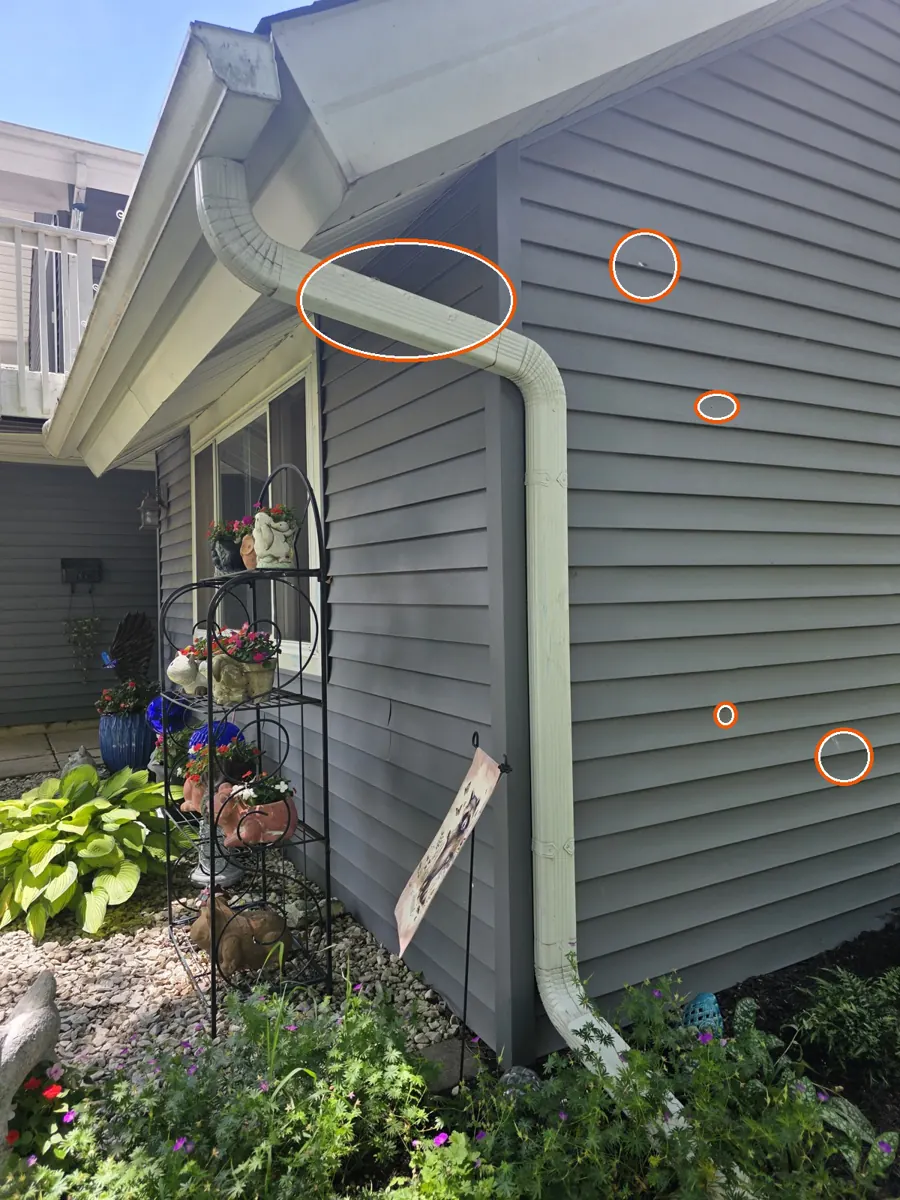 Hits on the siding or window screens, circled on a C&N Construction job photo in Hanover Park, IL