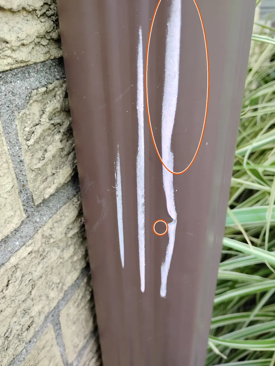 Dents in the gutters or other soft metal, circled on a C&N Construction job photo in Lombard, IL