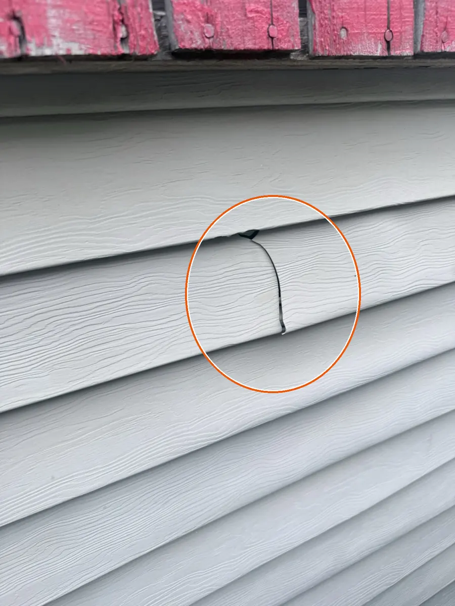 Dents in the gutters or other soft metal, and hits on the siding or window screens, circled on a C&N Construction job photo in Arlington Heights, IL
