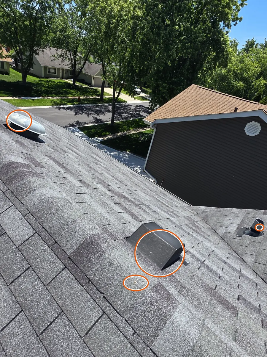 Dents in the gutters or other soft metal, circled on a C&N Construction job photo in Hanover Park, IL