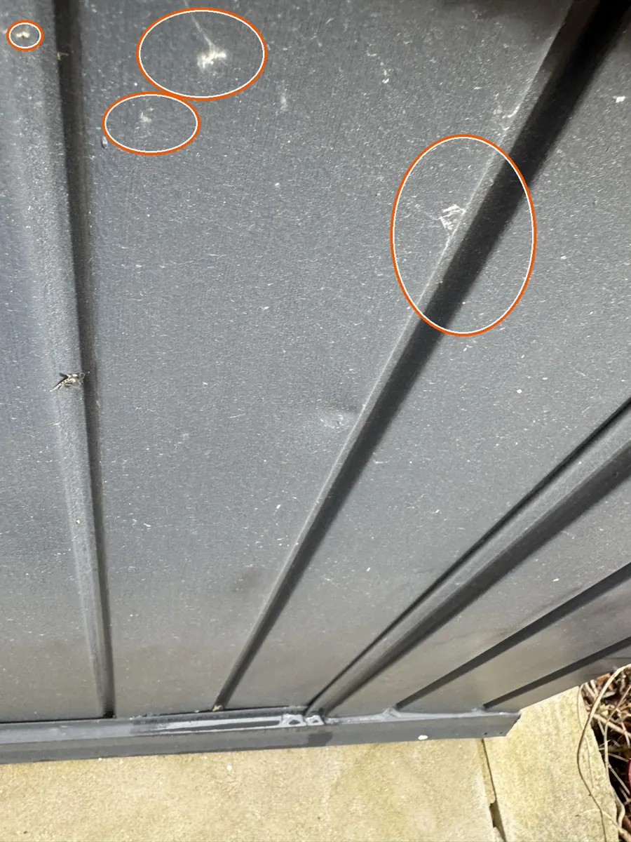 Dents in the gutters or other soft metal, circled on a C&N Construction job photo in the Chicago suburbs