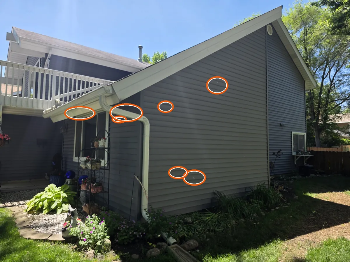 Hits on the siding or window screens, circled on a C&N Construction job photo in Hanover Park, IL