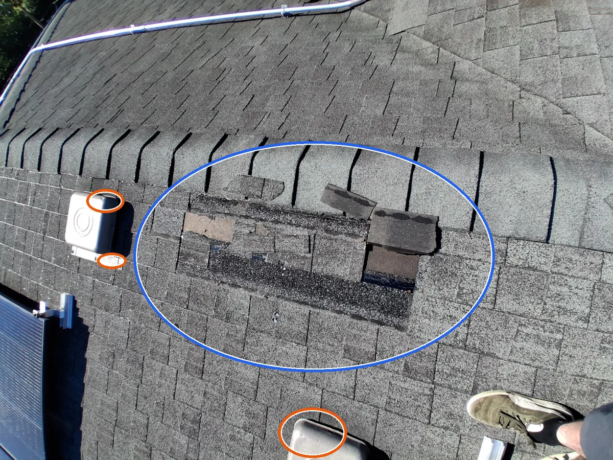 Exposed underlayment, and dents in the gutters or other soft metal, circled on a C&N Construction job photo in the Chicago suburbs