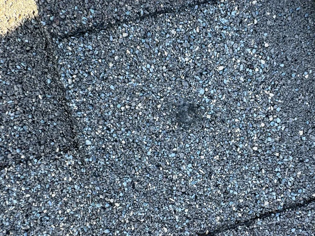 Close-up of shingle surface showing damage area