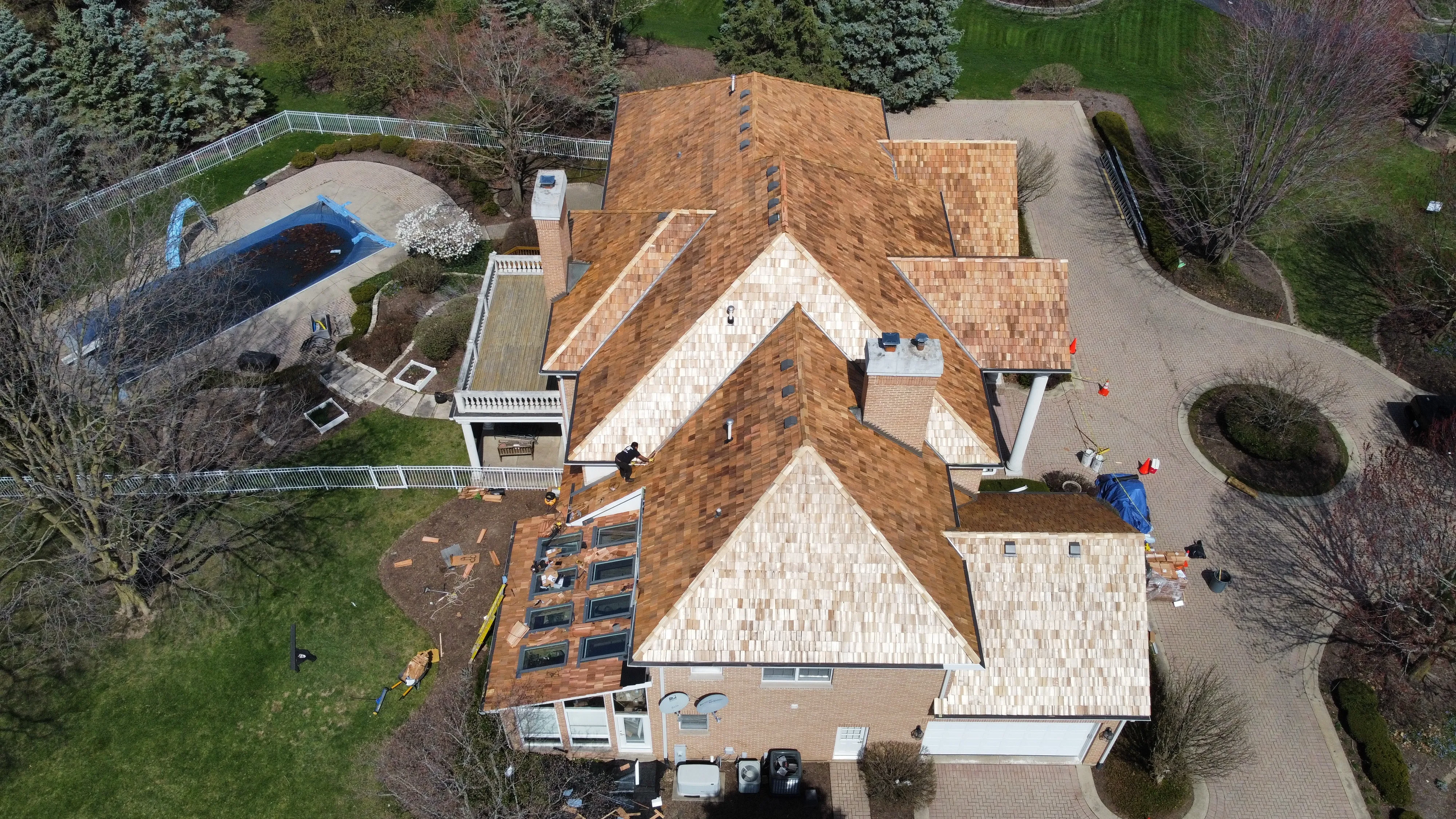 Aerial view of roof tear-off showing exposed decking with crew