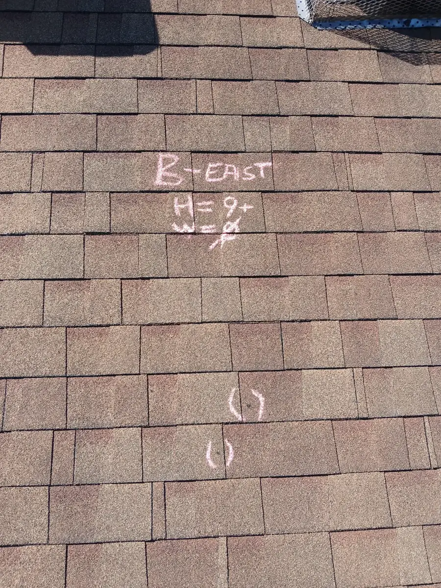 Chalk on a shingle roof reading B-EAST, H=9+, W=0, with circled hits below