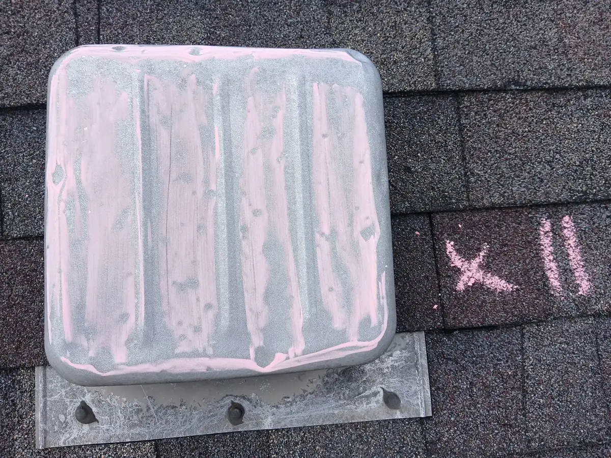 A metal box vent rubbed with chalk to show dents, with x 11 written beside it
