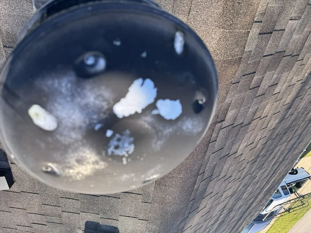 Residential roof showing potential leak source at vent