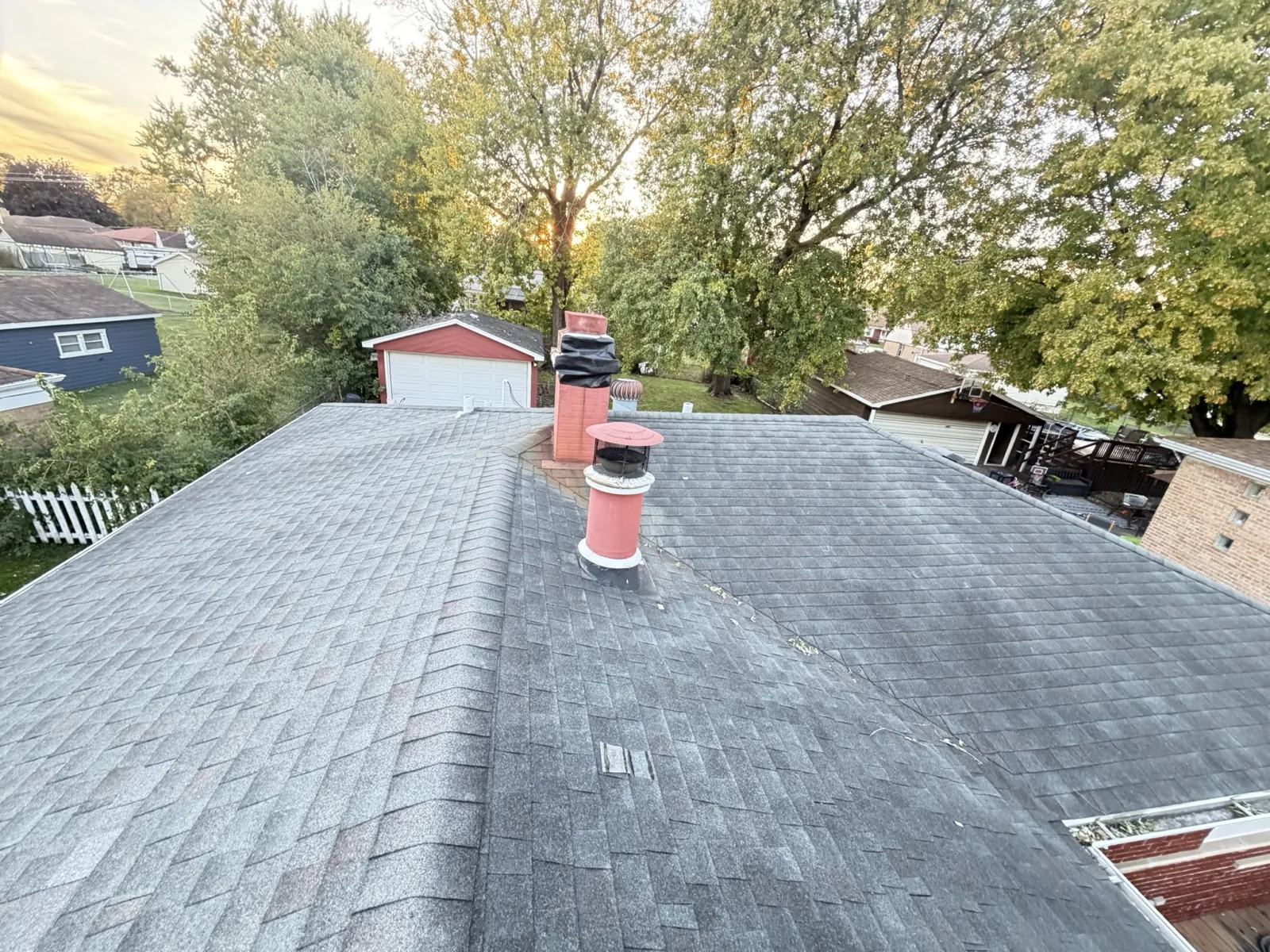 New gray architectural shingle roof with red chimney accents in Alsip, IL