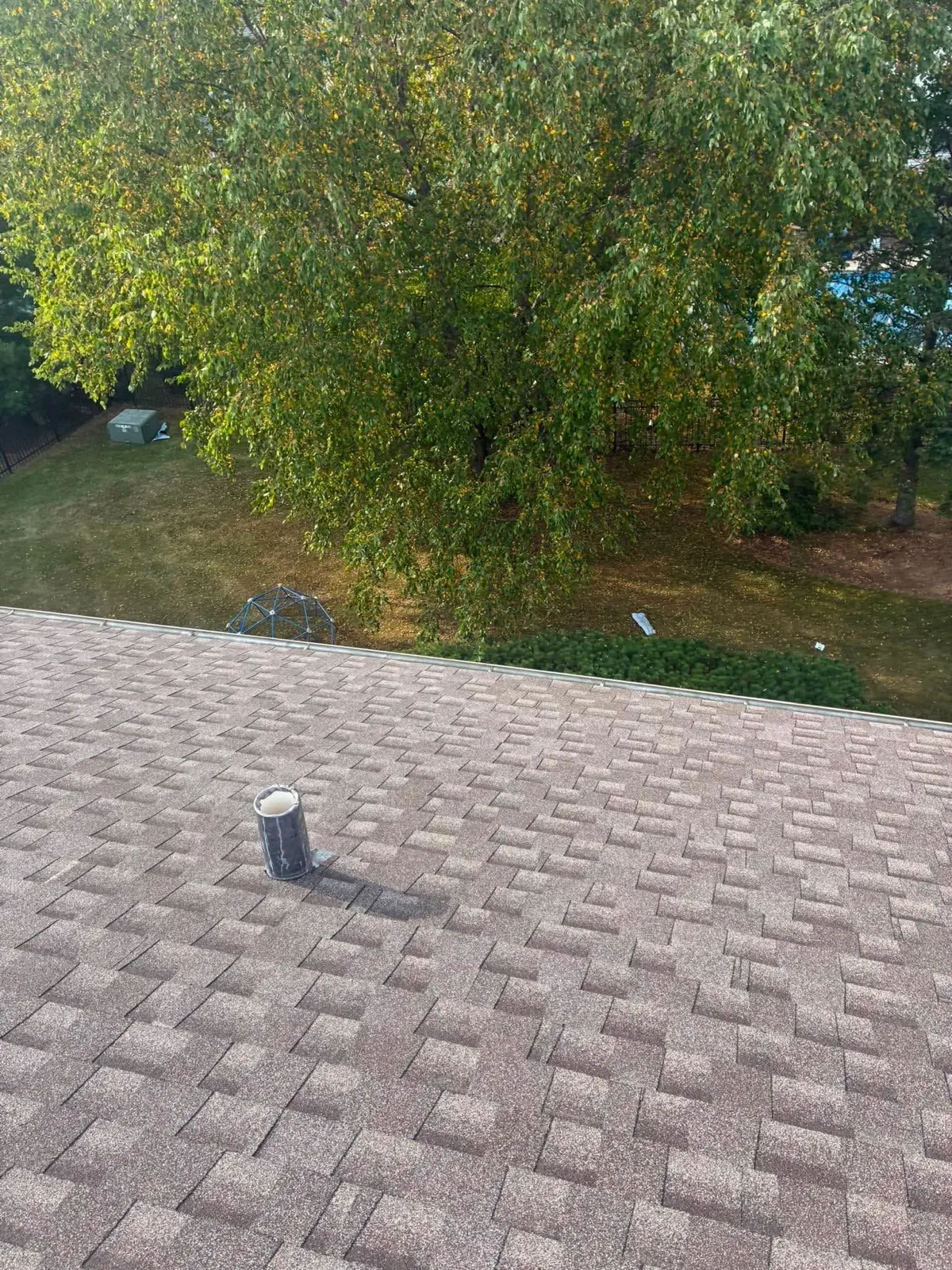 New brown architectural shingle roof with a vent pipe in Bartlett, IL