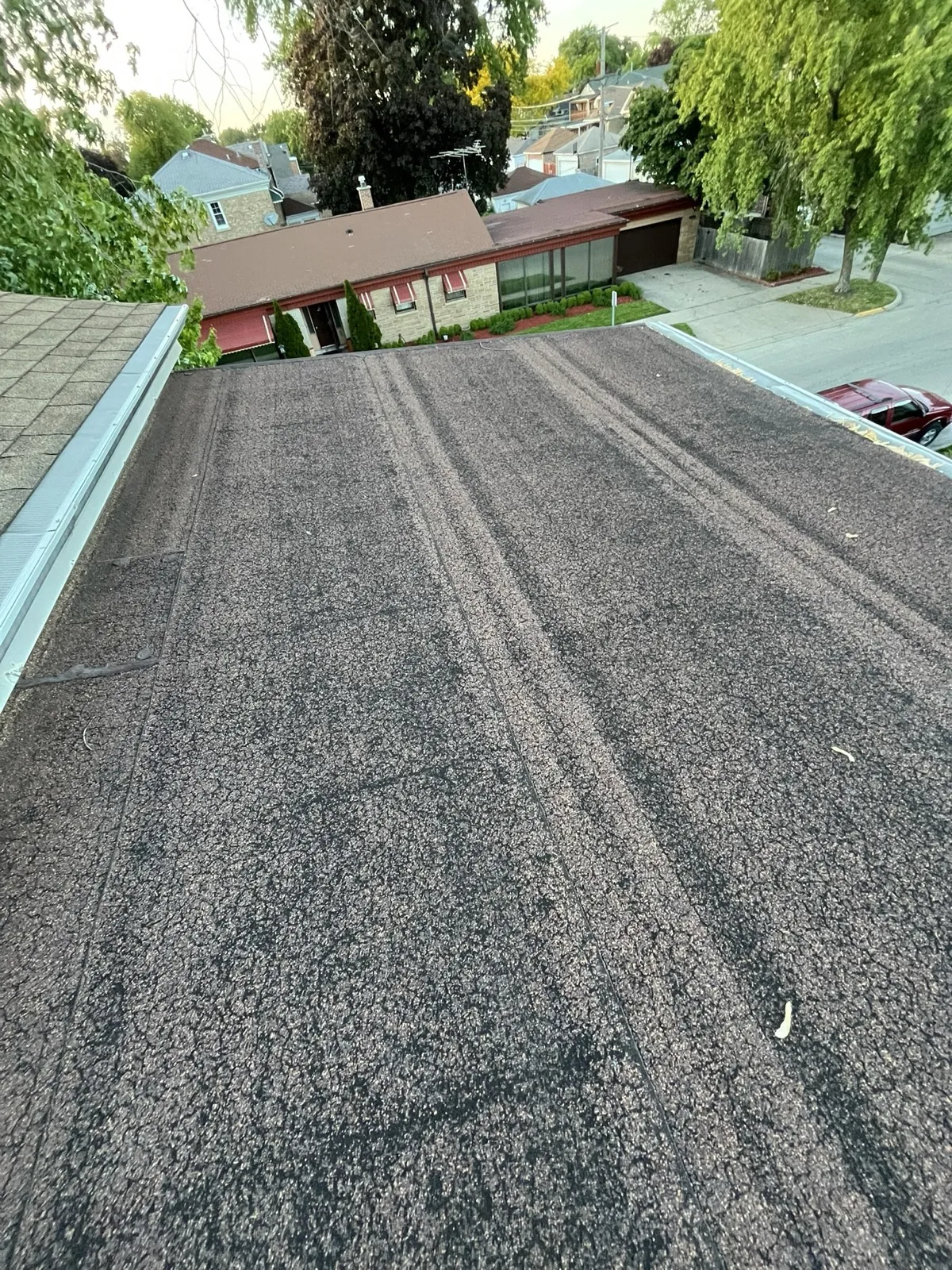A flat roof with a textured surface and metal flashing in Berwyn, IL