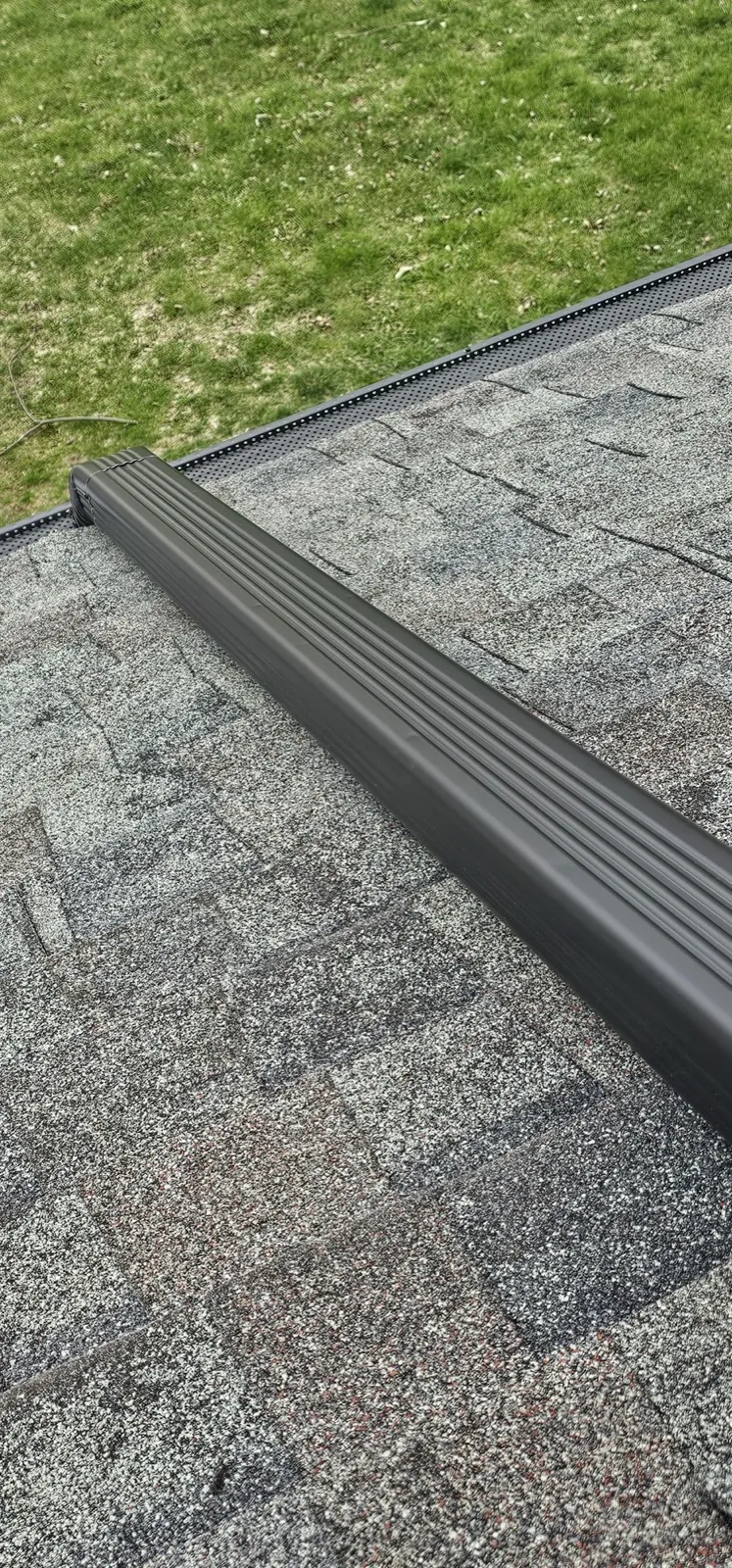 Close-up of a new asphalt architectural shingle roof with a ridge cap in Bloomingdale, IL