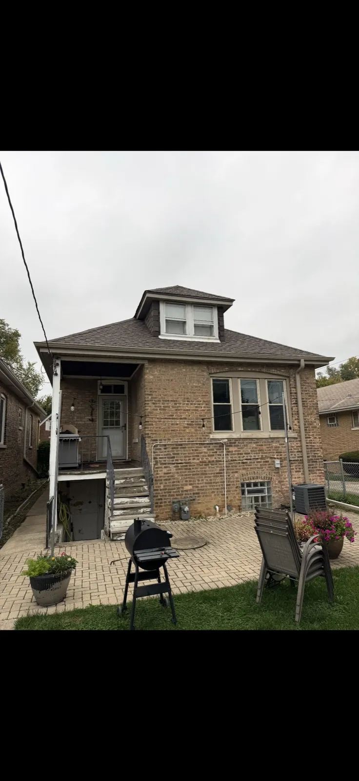 New asphalt architectural shingle roof on a brick home with a dormer in Brookfield, IL