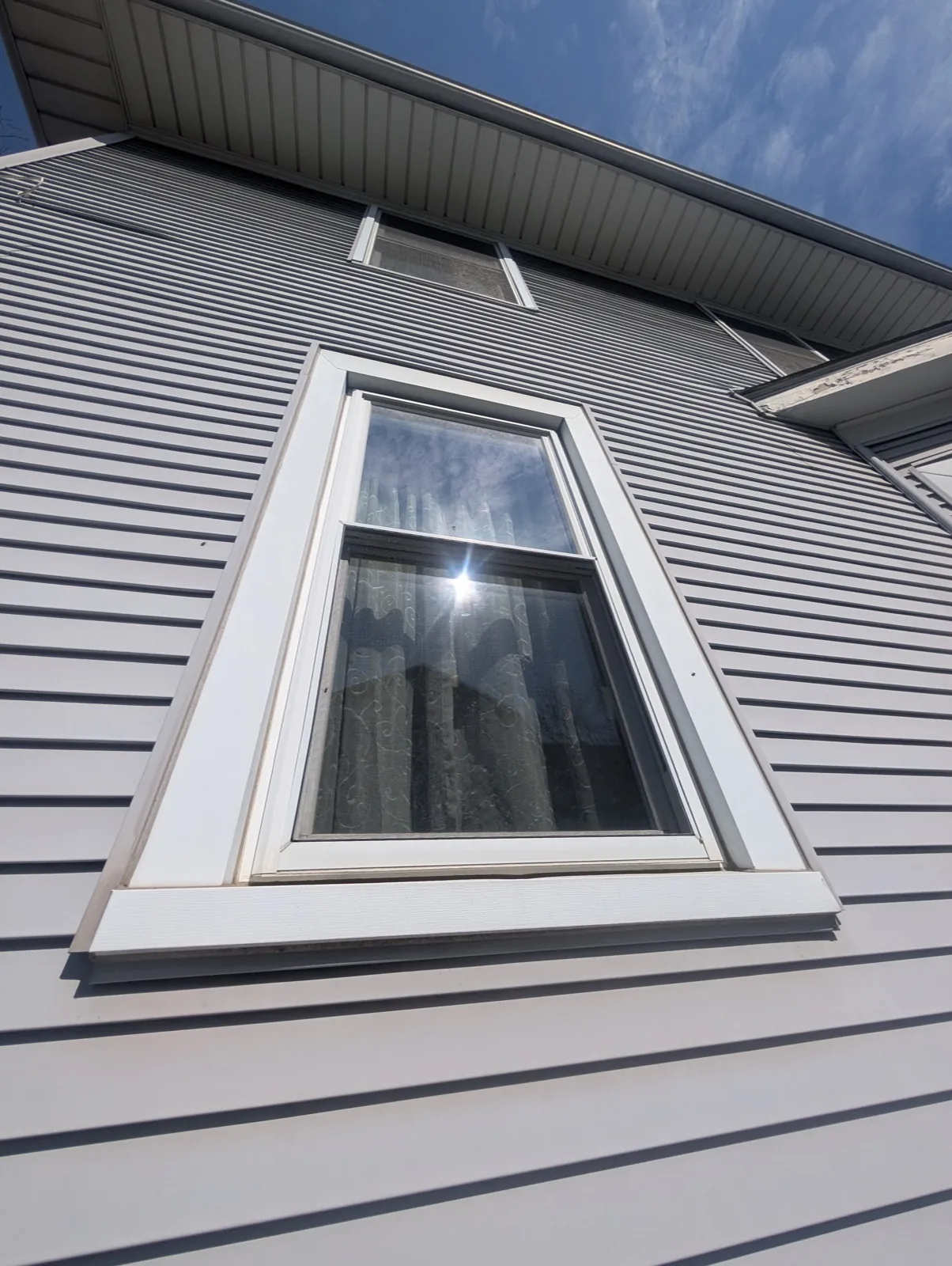 New gray vinyl siding installed on a residential home in Brookfield, IL