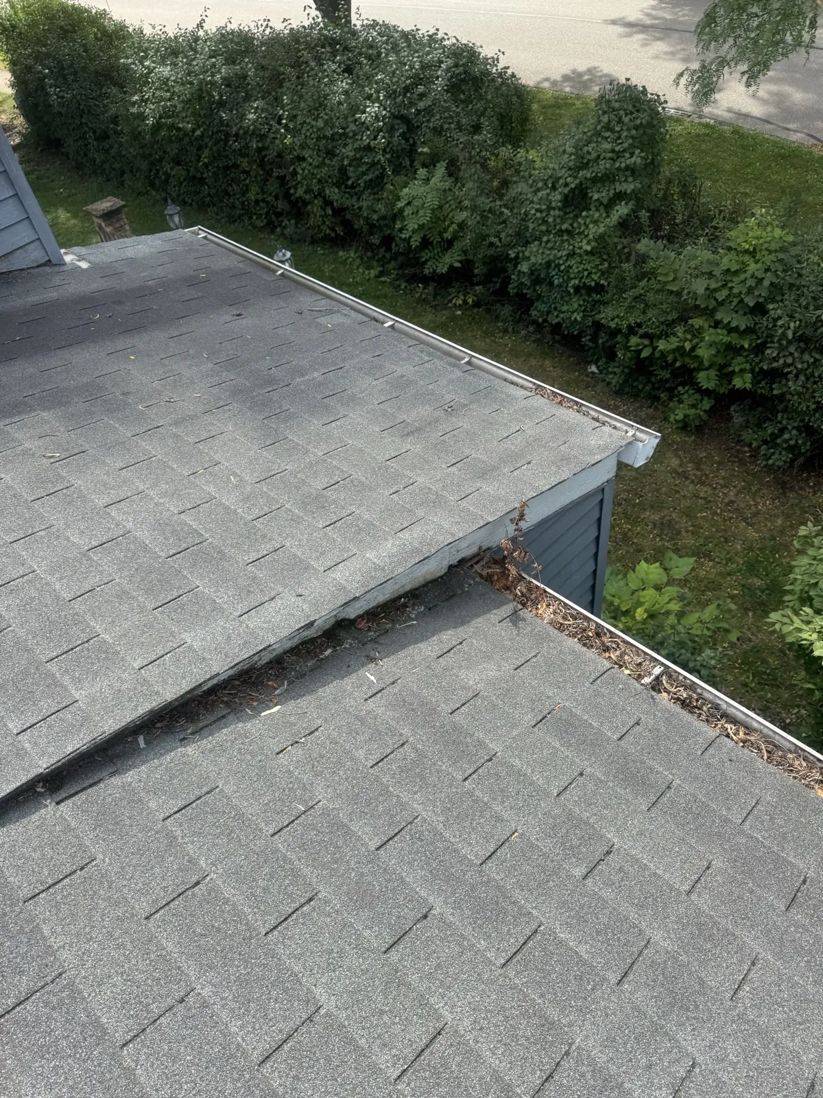 A gray asphalt architectural shingle roof with a valley and integrated flashing in Buffalo Grove, IL
