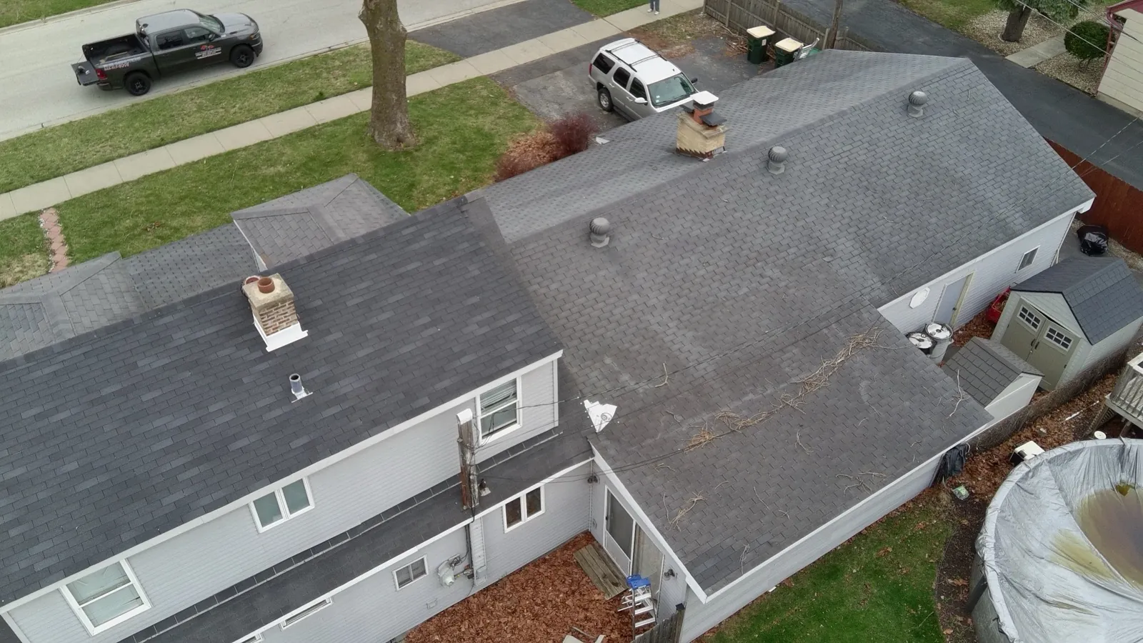 Aerial view of a new charcoal gray architectural shingle roof on a multi-level home in Burbank, IL