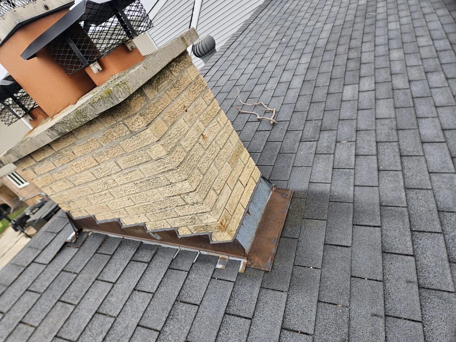 New charcoal architectural shingle roof installed on a home with stone accents in Burbank, IL