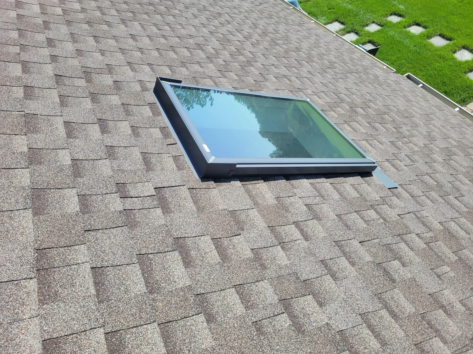 A new asphalt architectural shingle roof featuring a skylight installation in Burr Ridge, IL
