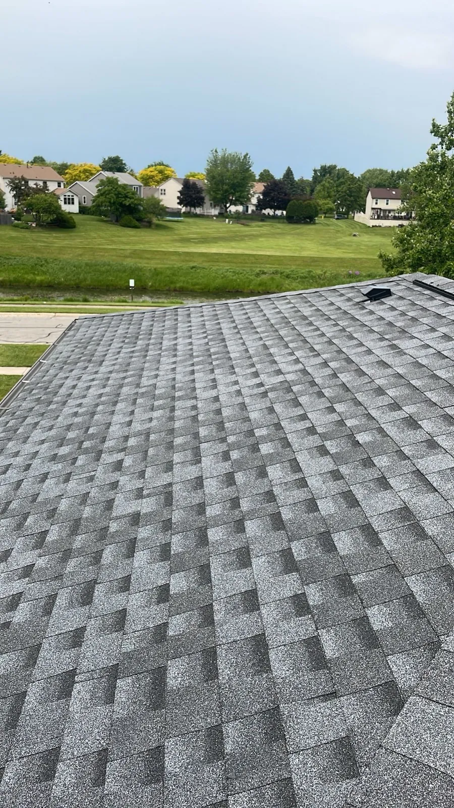 New charcoal gray architectural shingle roof on a residential home in Carol Stream, IL