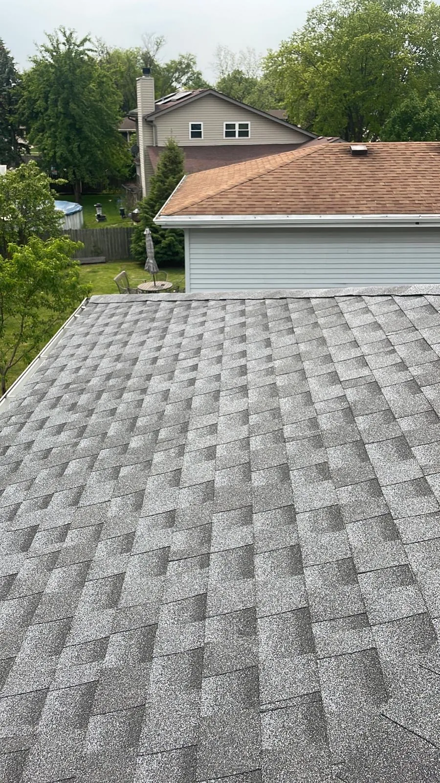 New charcoal gray architectural shingle roof on a residential home in Carol Stream, IL
