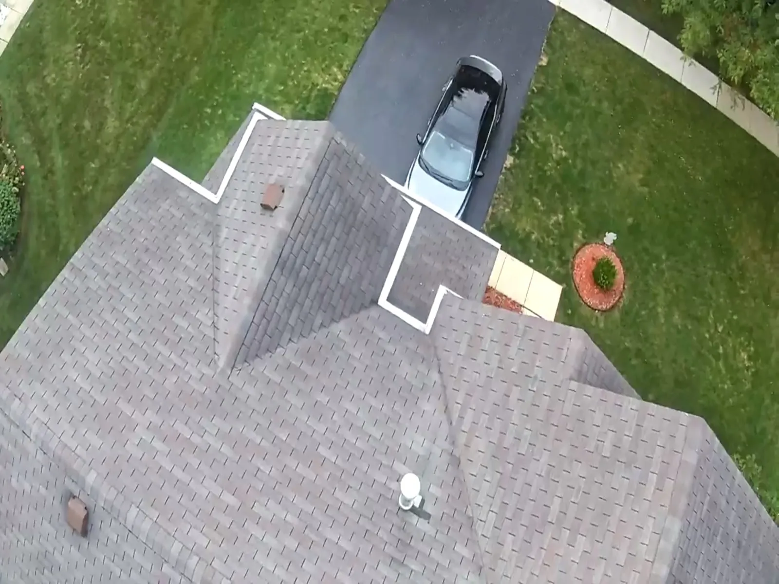 Aerial view of a new gray architectural shingle roof on a residential home in Carpentersville, IL