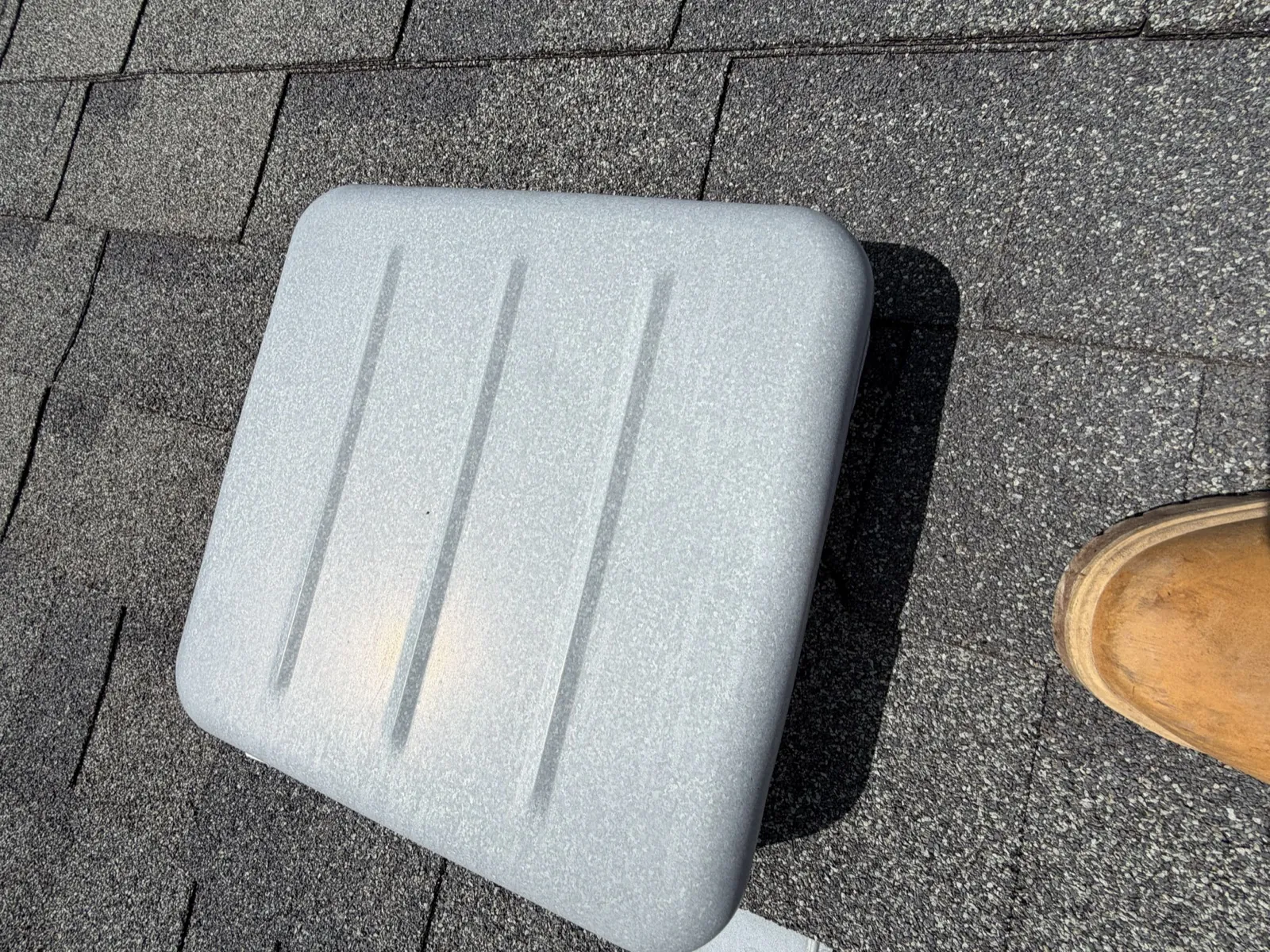 Close-up of a new asphalt architectural shingle roof with a skylight in Cicero, IL