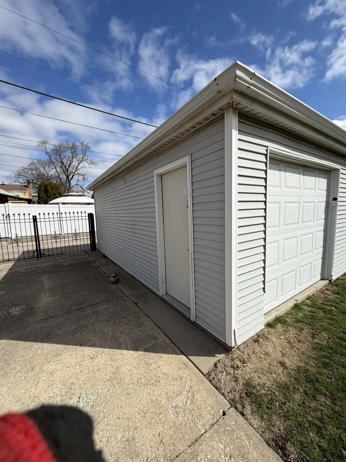 White vinyl siding on a garage with a matching garage door in Cicero, IL