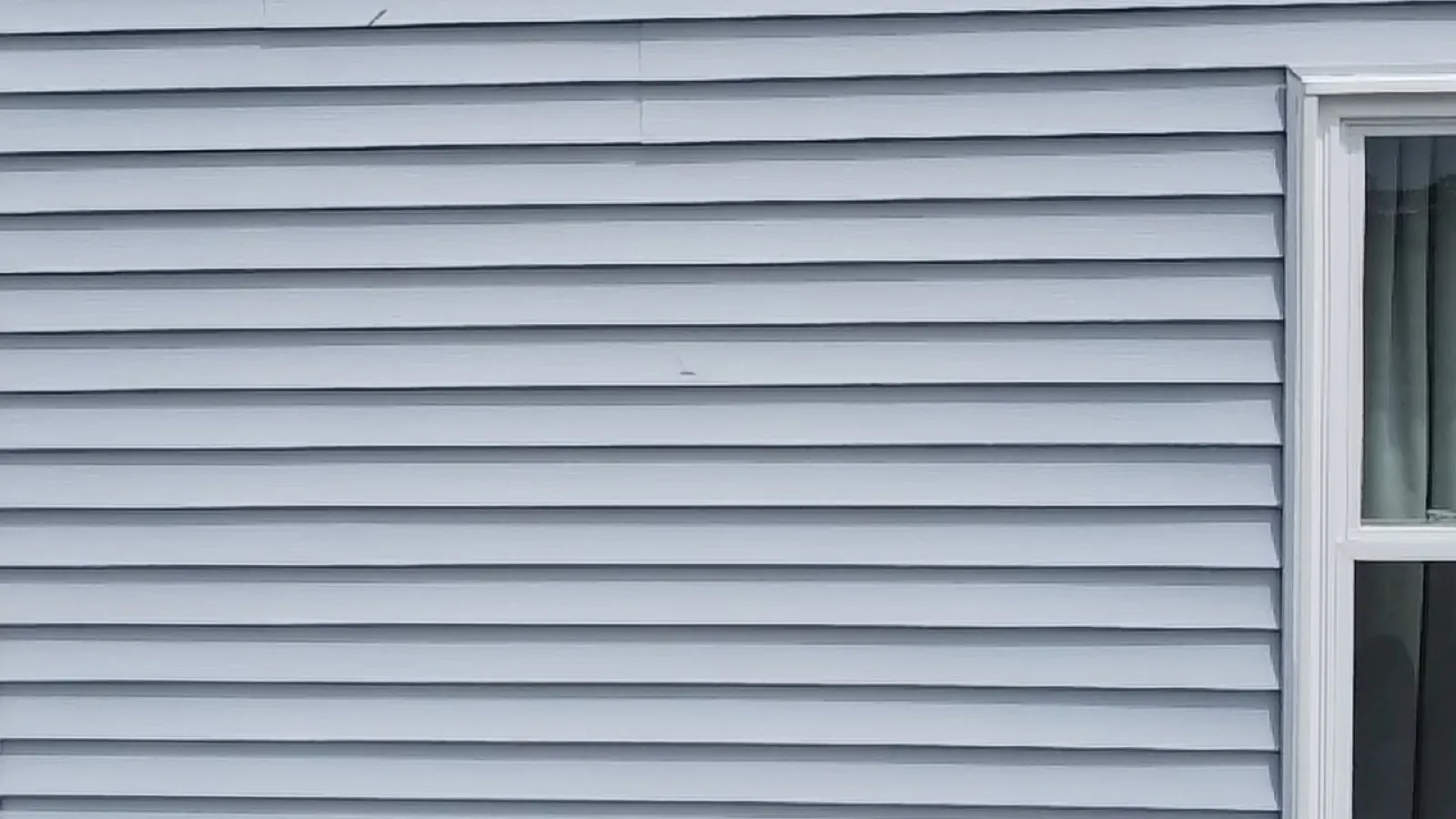 Light blue vinyl siding installed on a home exterior in Crest Hill, IL