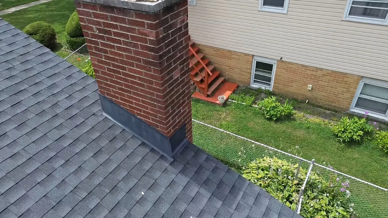 New charcoal architectural shingle roof with a brick chimney in Darien, IL