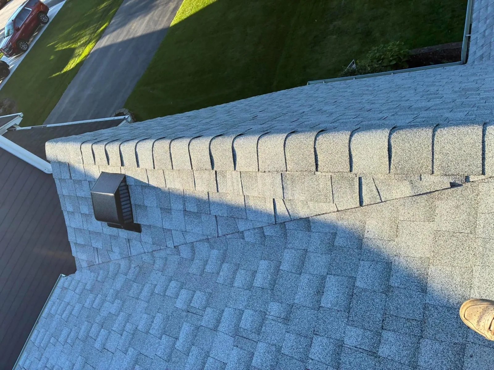 New gray architectural shingle roof with a finished ridge and hip detail in Downers Grove, IL
