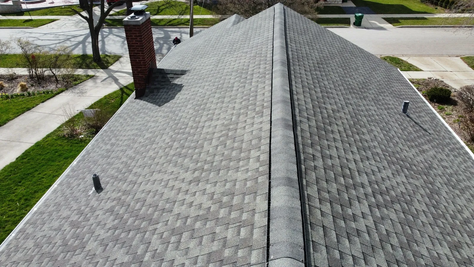 New gray architectural shingle roof with a brick chimney in Elgin, IL