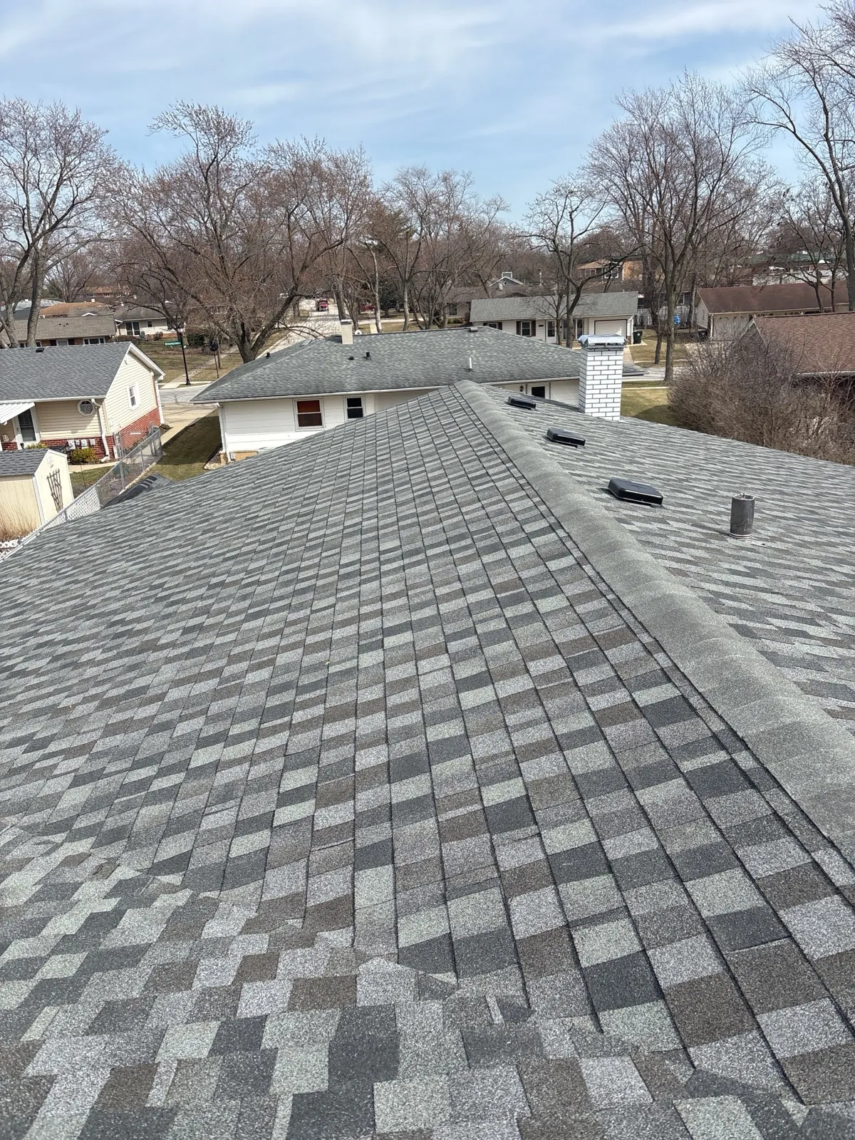 New charcoal gray architectural shingle roof on a residential home in Elk Grove Village, IL