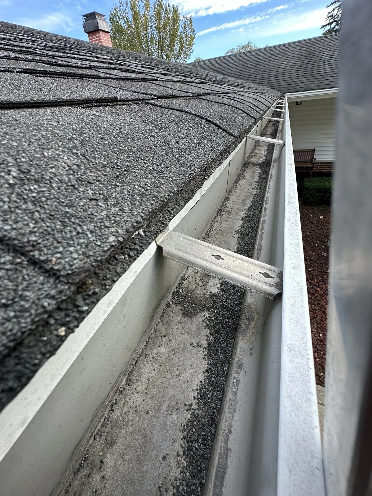 New white gutters installed on a home with a charcoal asphalt shingle roof in Elk Grove Village, IL