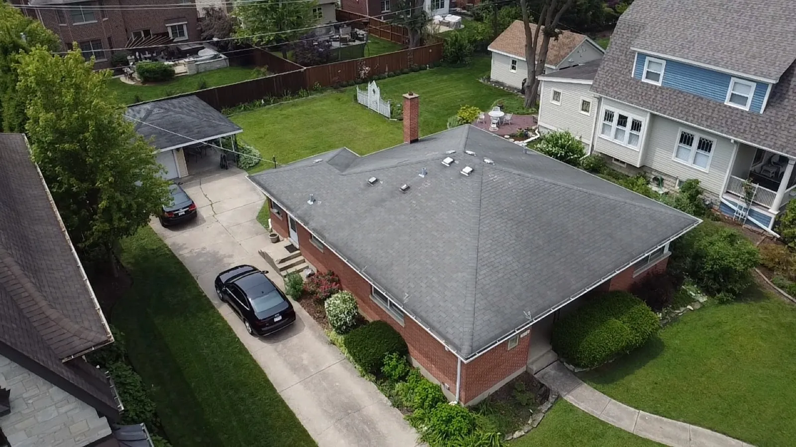 New grey asphalt architectural shingle roof on a brick bungalow in Elmhurst, IL