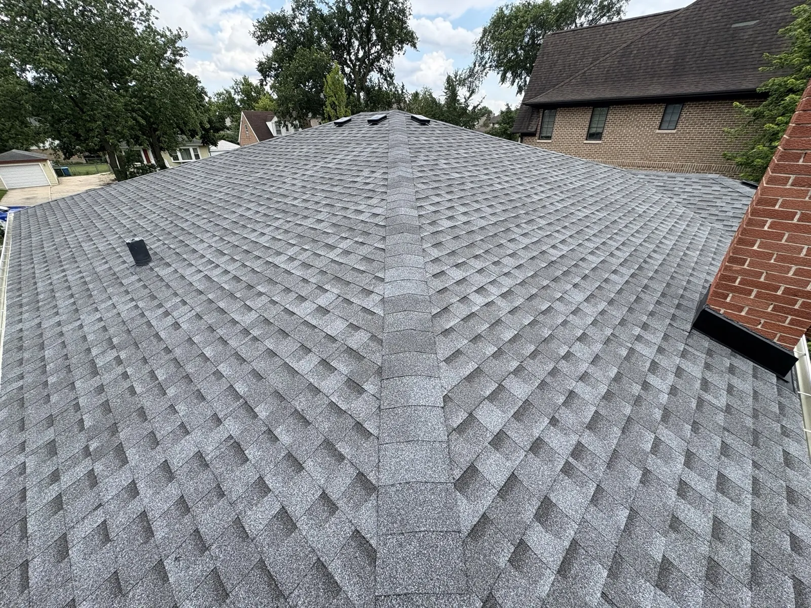 New charcoal gray architectural shingle roof on a residential home in Elmhurst, IL