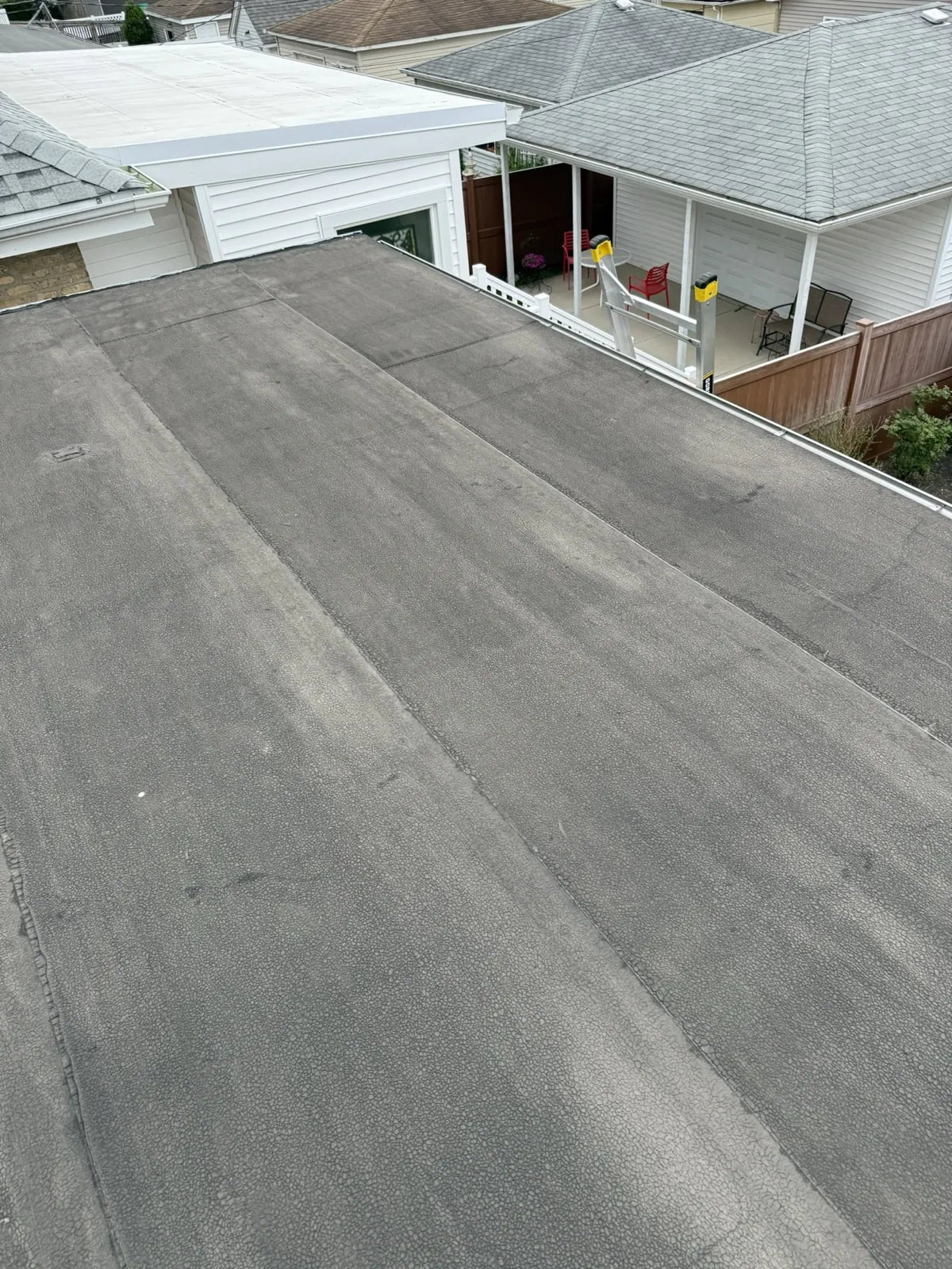 A flat roof with a dark gray membrane surface in Elmwood Park, IL