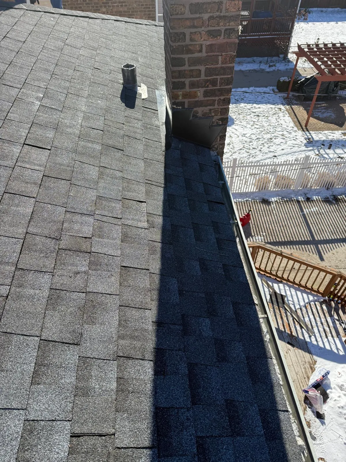 New charcoal architectural shingle roof installed on a brick chimney in Evergreen Park, IL
