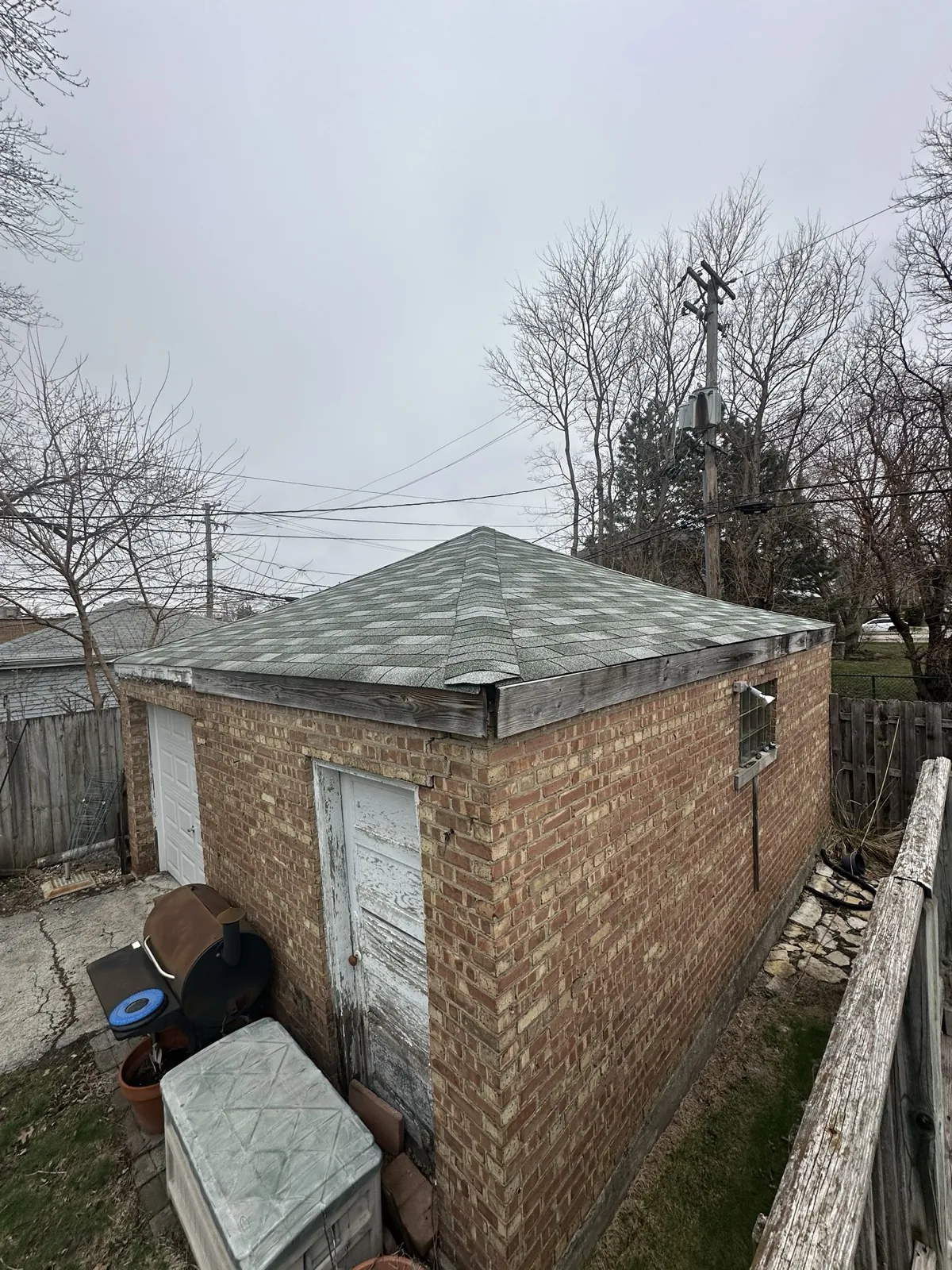 New gray asphalt architectural shingle roof on a brick outbuilding in Evergreen Park, IL