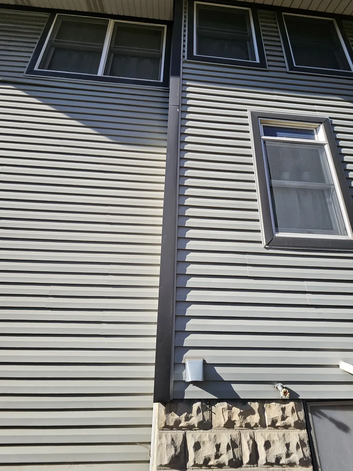 Gray fiber cement siding installed on a residential building in Forest Park, IL