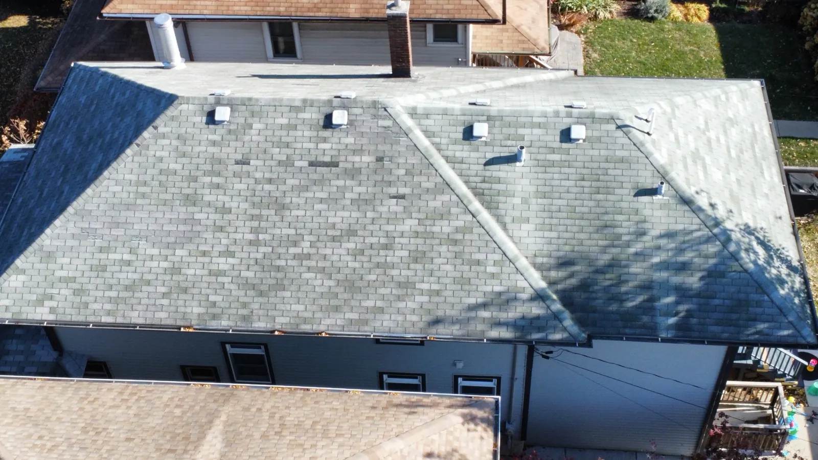 New gray architectural shingle roof on a multi-level home in Forest Park, IL