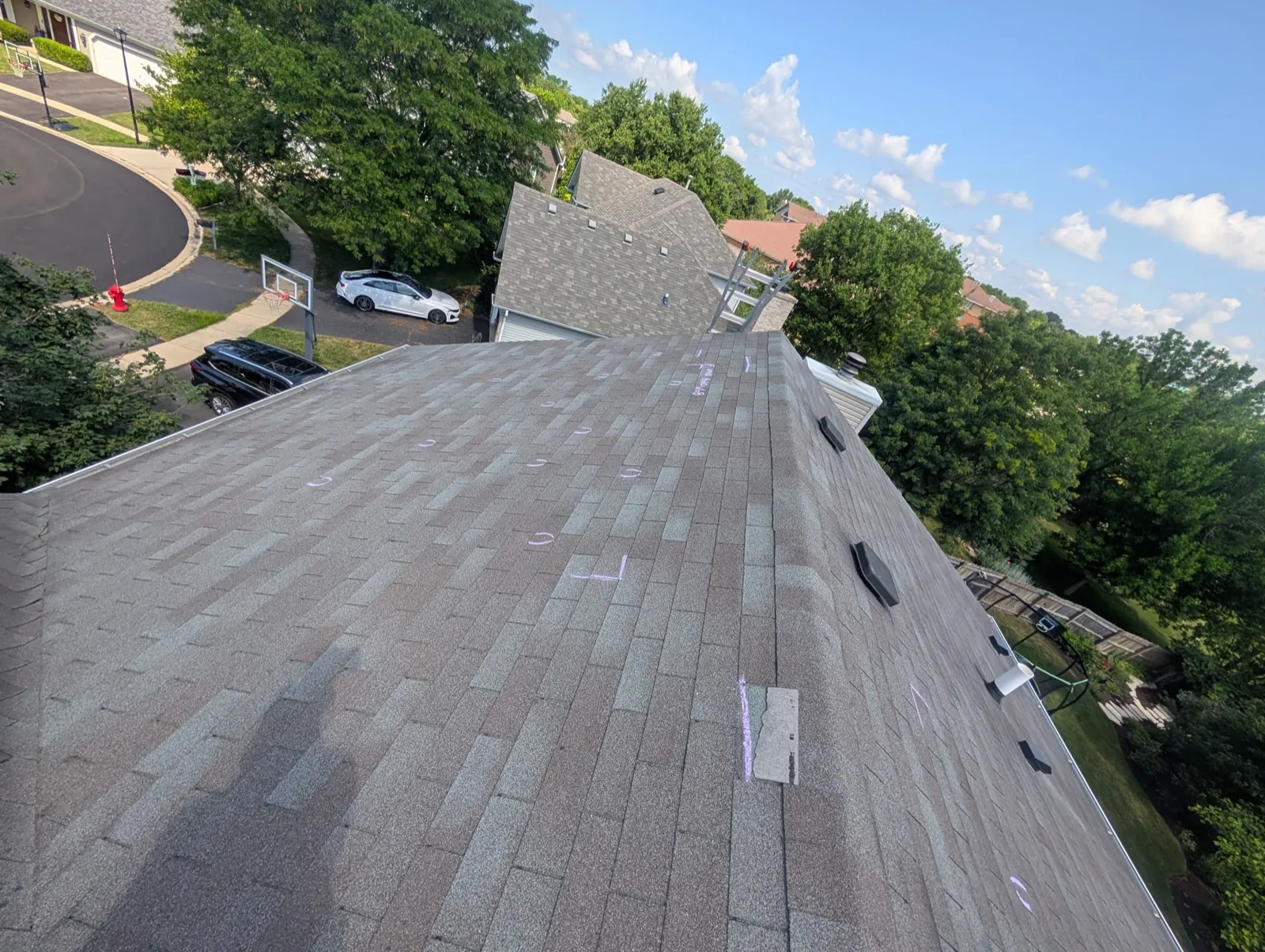 A new asphalt architectural shingle roof installation with chalk markings for layout in Geneva, IL