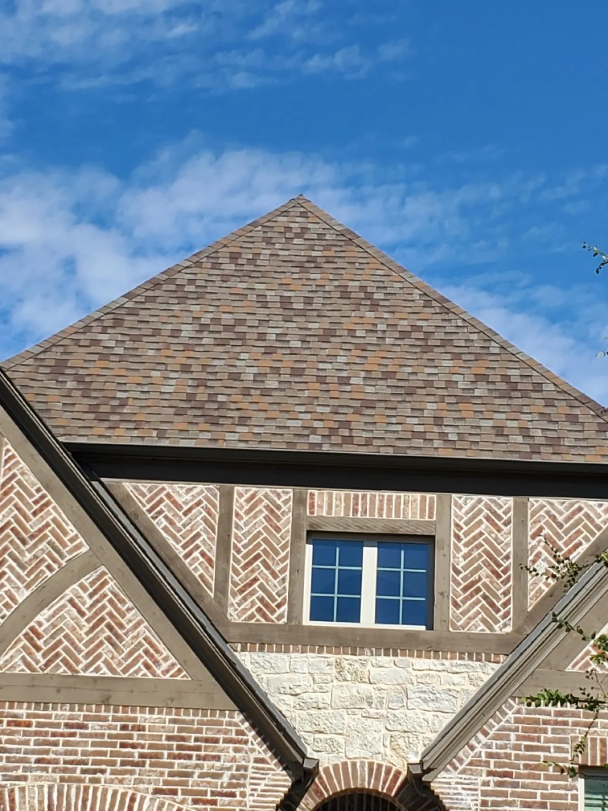New multi-toned architectural shingle roof on a brick and timber home in Geneva, IL