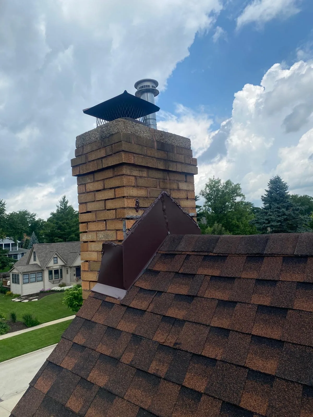 New brown architectural shingle roof with a brick chimney in Glen Ellyn, IL