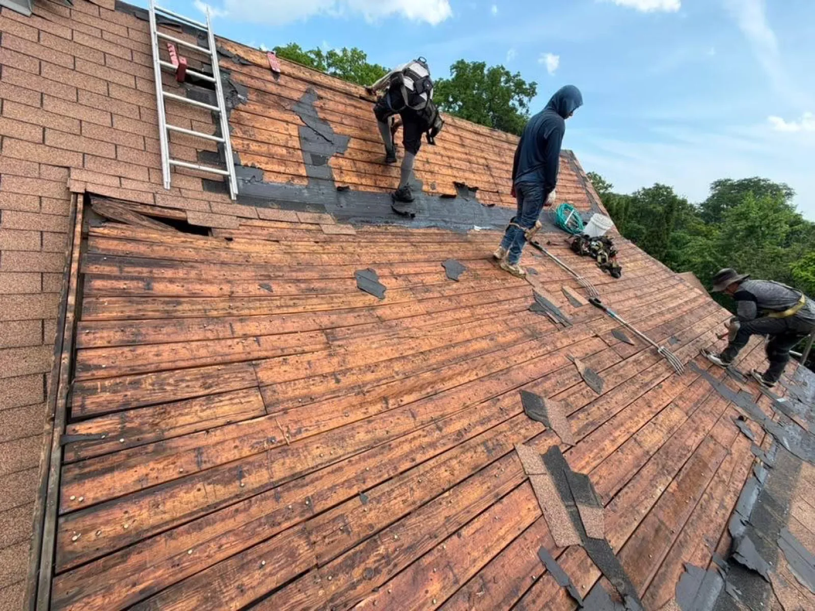 Roofing crew installing cedar shakes on a large roof in Glen Ellyn, IL
