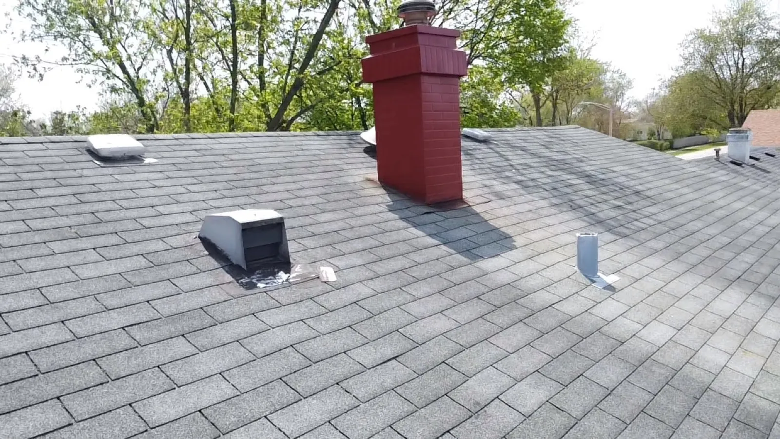 New gray asphalt architectural shingle roof with a red brick chimney in Glendale Heights, IL