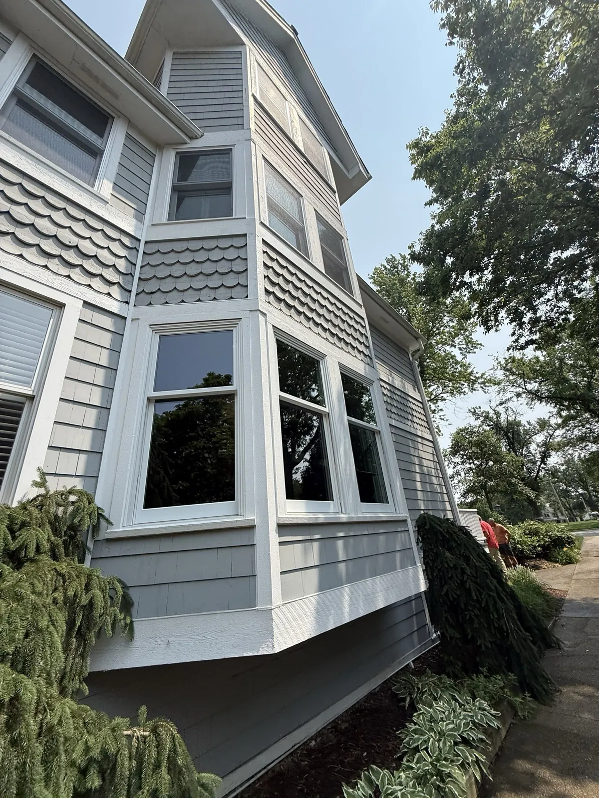 Gray fiber cement siding with decorative scalloped shingles on a multi-story home in Hinsdale, IL