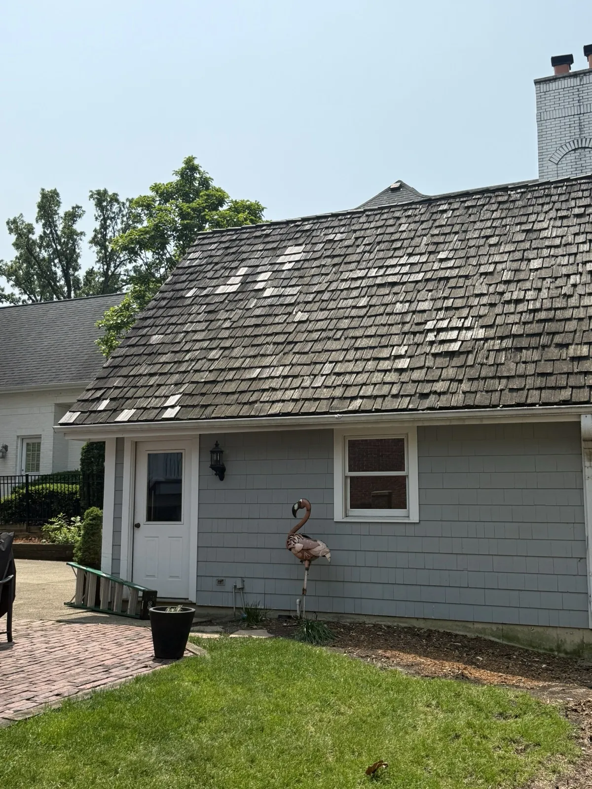 A cedar shake roof on a gray shingled building in Hinsdale, IL
