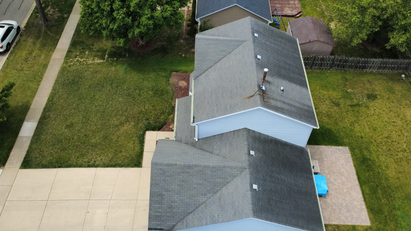 Aerial view of a new charcoal gray architectural shingle roof on a residential home in Hoffman Estates, IL