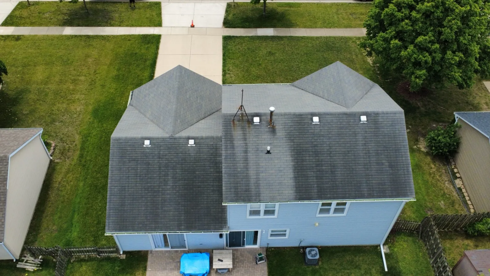 Aerial view of a new gray asphalt architectural shingle roof on a two-story home in Hoffman Estates, IL