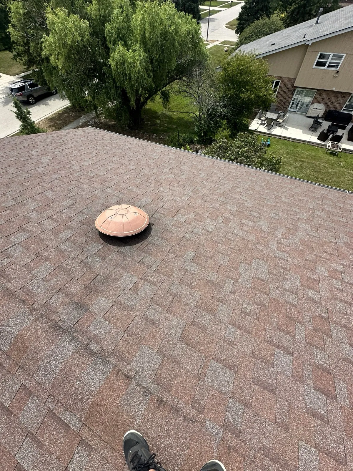 New brown architectural shingle roof with a matching roof vent in Homer Glen, IL